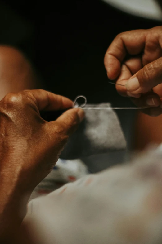 a person with their hand on a piece of clear material