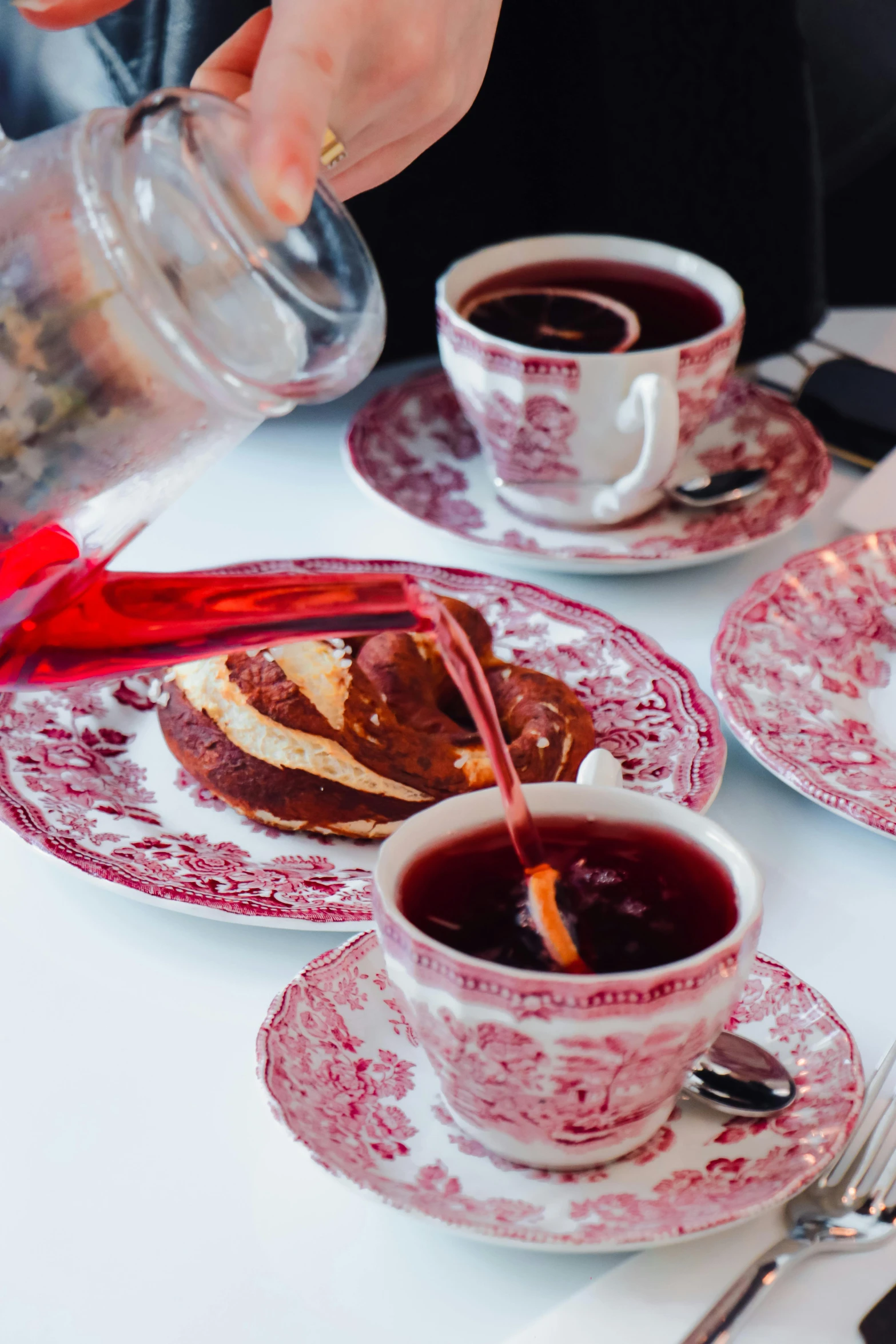 a person pours tea into a cup