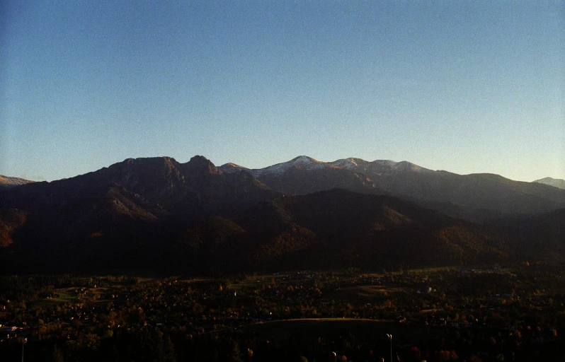 the mountains range against the blue sky and clear blue water