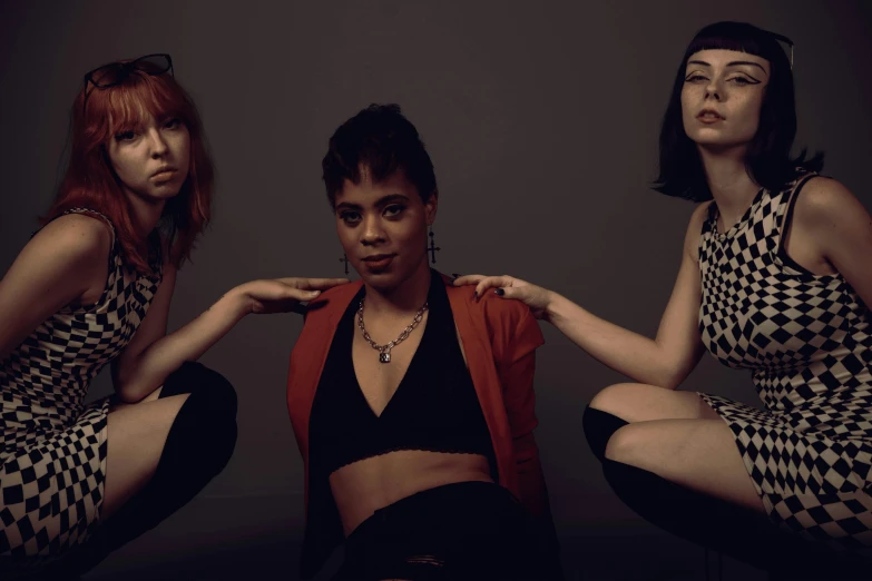 three women wearing checked outfits and red hair