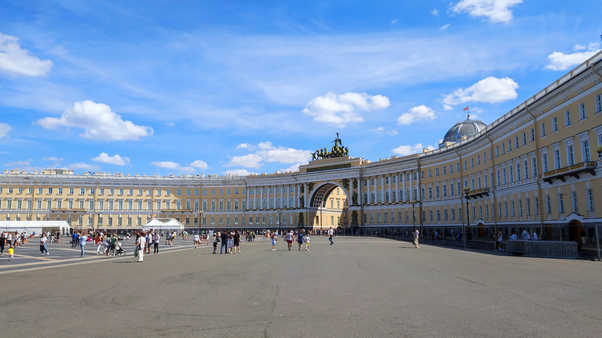 a crowd of people in front of a huge building