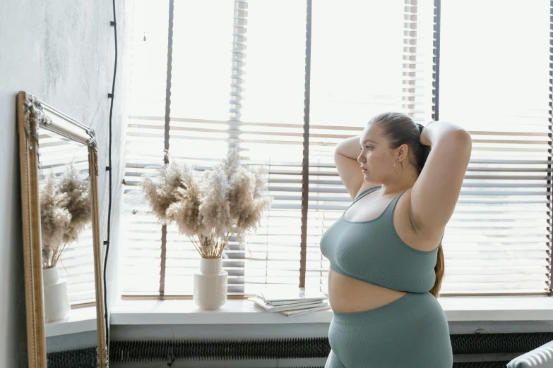 a woman taking a selfie in front of a mirror