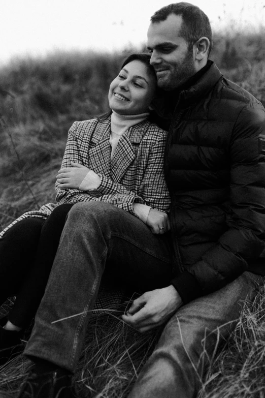 black and white po of two people in grass