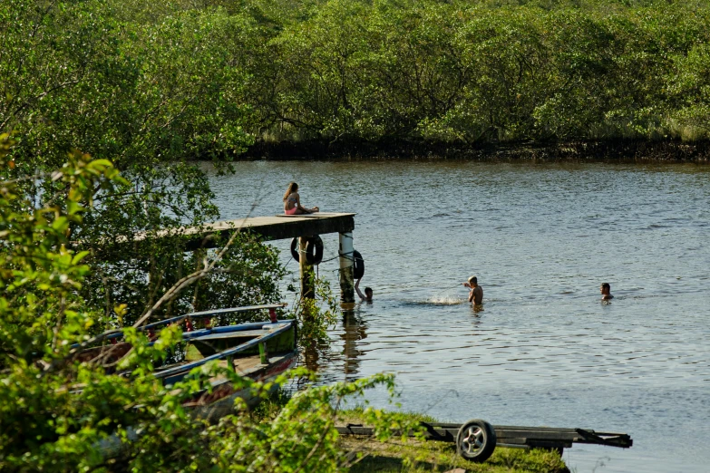 a small dock that has people floating in the water