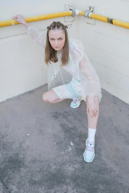 a person standing on a concrete floor in white clothes