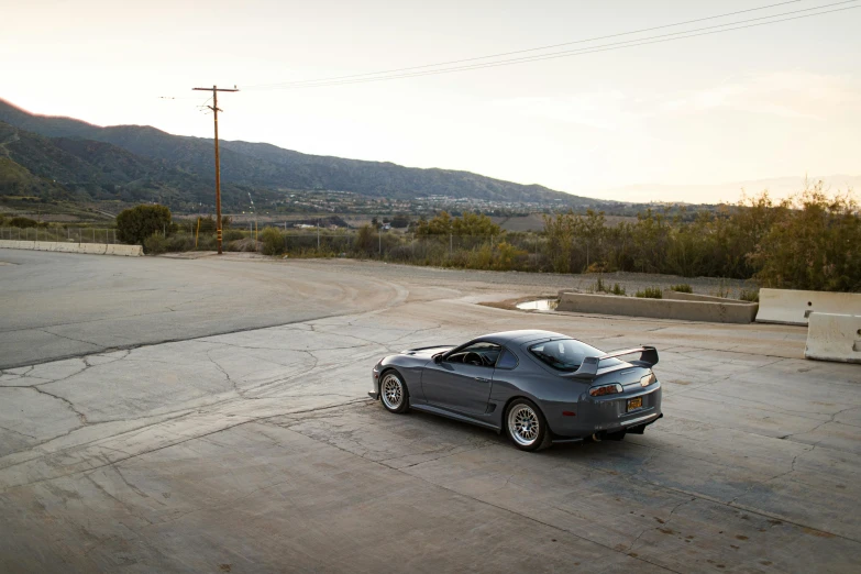 a parked sports car on an empty road