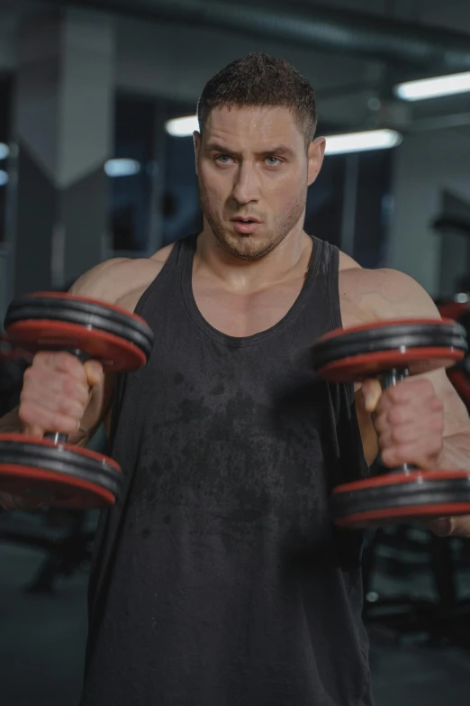 a man working out with a dumb presses