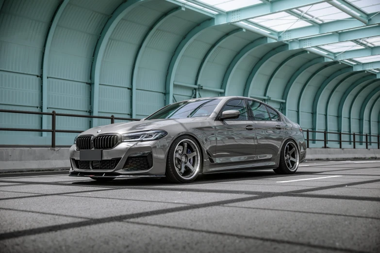 a silver bmw parked in a parking space