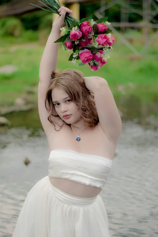 a woman holding bunches of flowers on her head