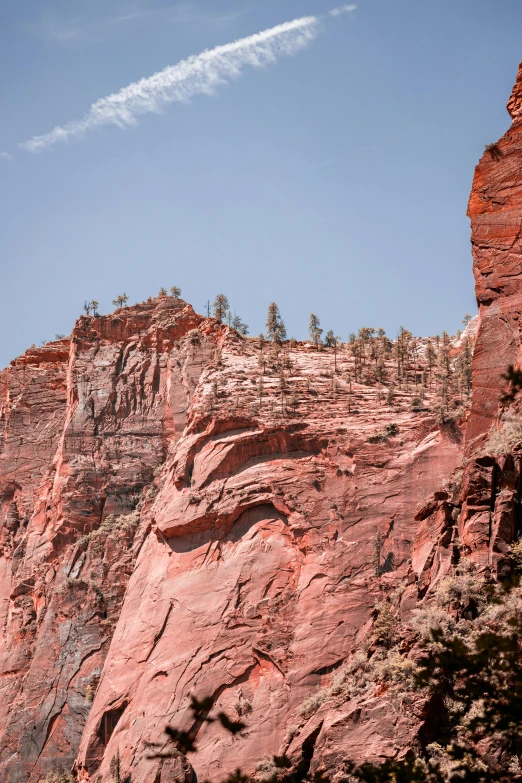 two planes fly high above a rock - topped mountain