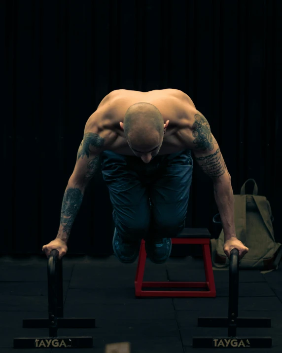 a man is doing h ups on a small bench