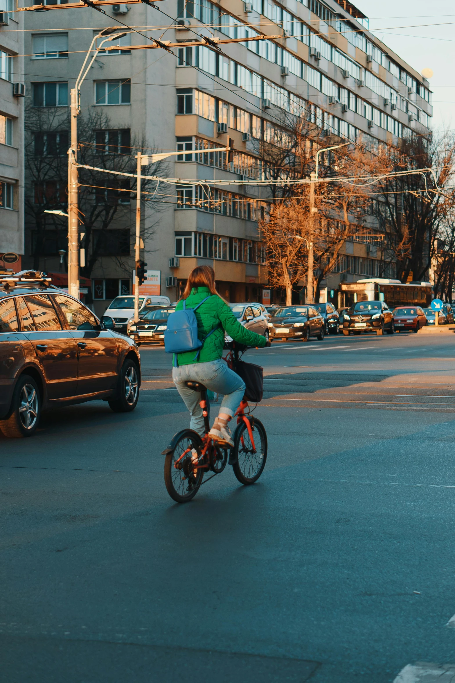 a person is on a bike in front of many cars