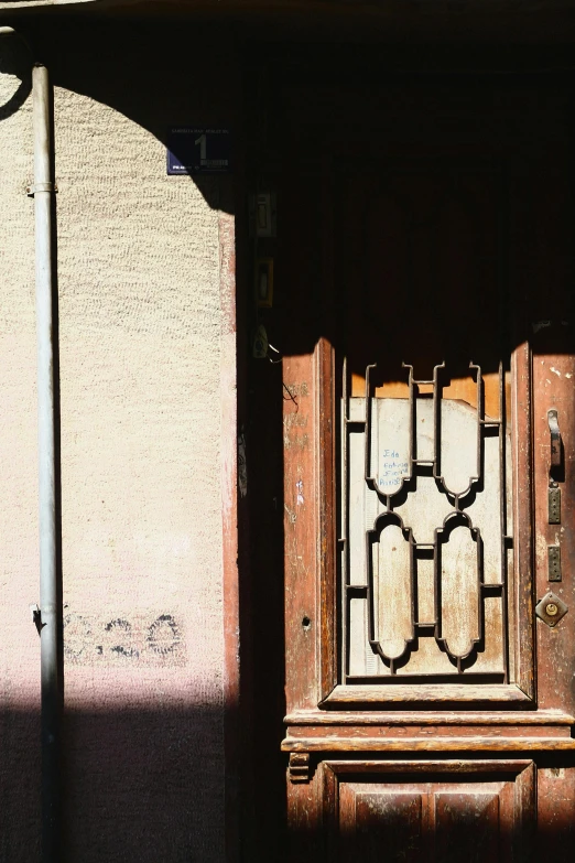 an old window with metal bars is placed on a building