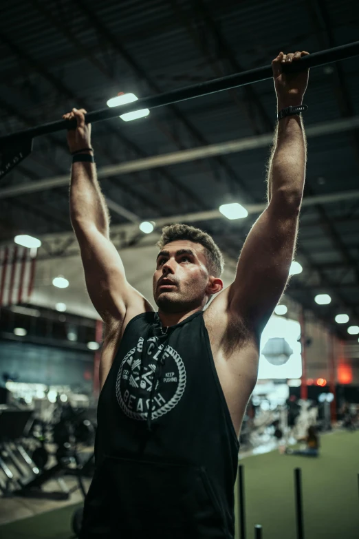 a man is in the gym doing pull ups