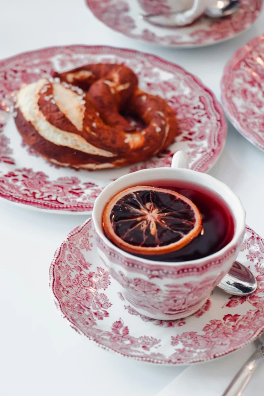 an assortment of desserts on small plates and a cup of tea