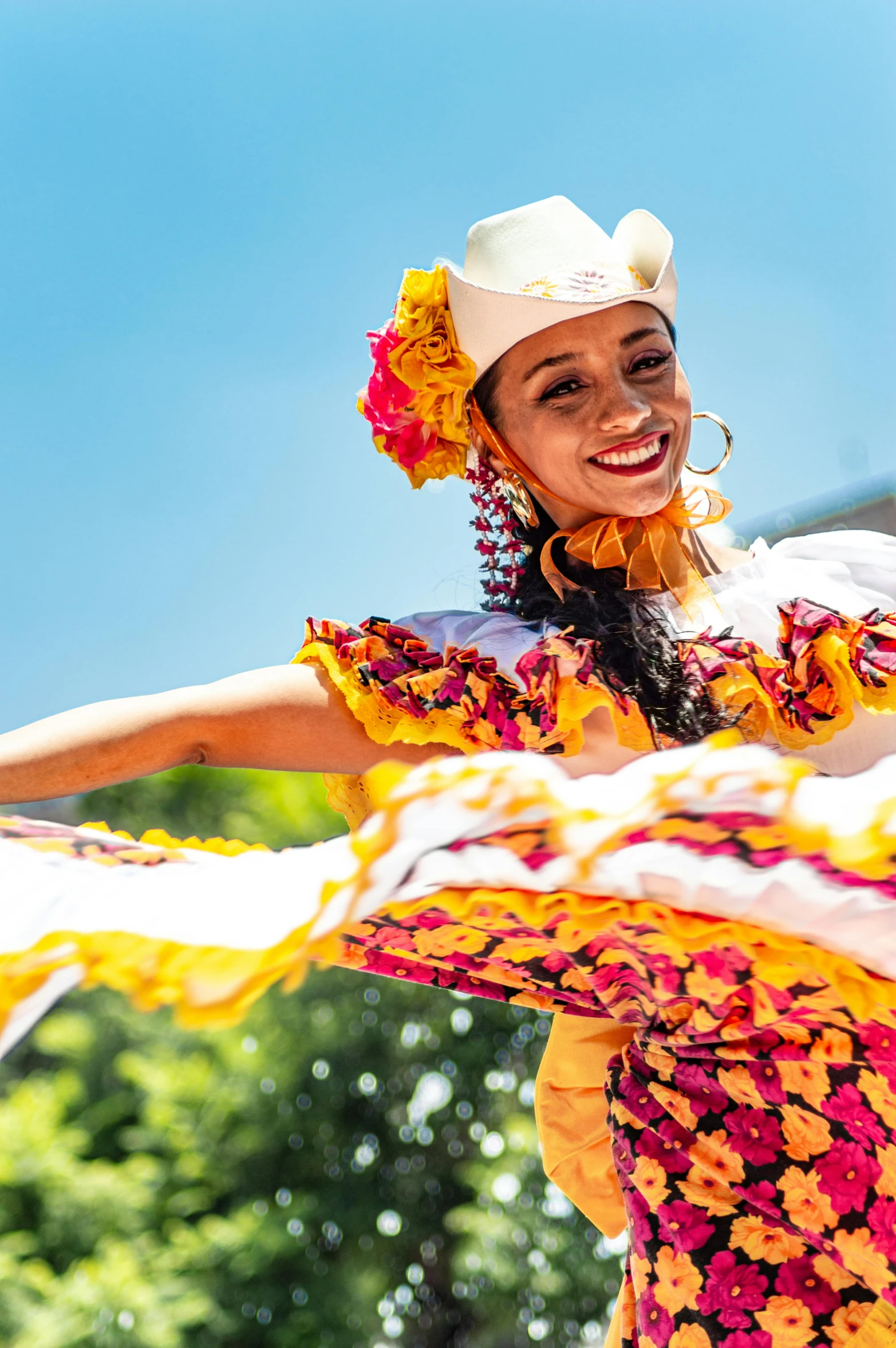 a smiling mexican woman dressed in traditional clothing