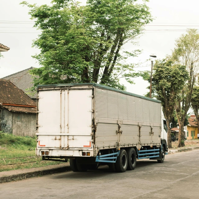 an old truck is parked on the side of the road