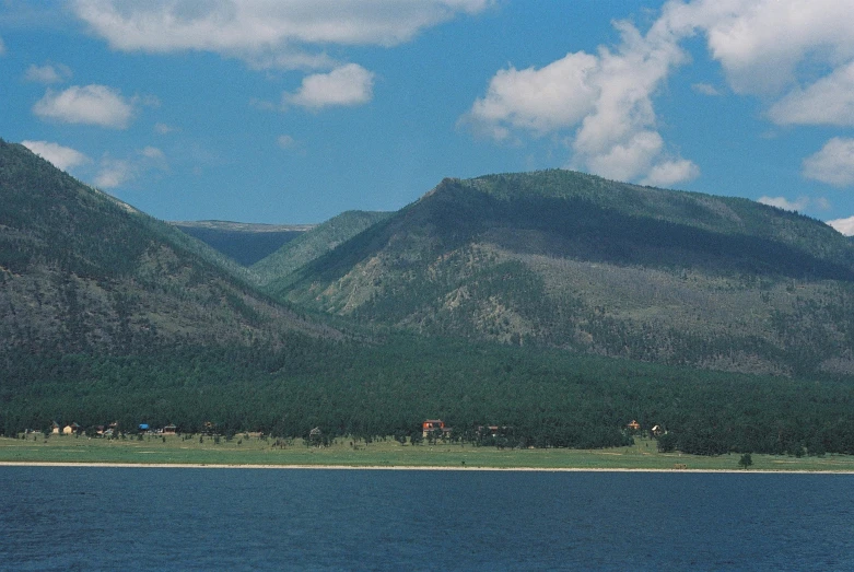 mountains surrounding the water are covered with trees