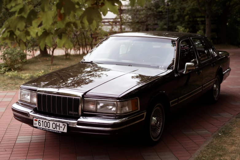 a black car with its hood open and lights on