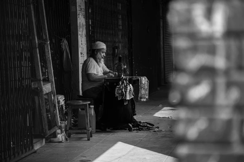 a man is sitting on a chair in a covered area