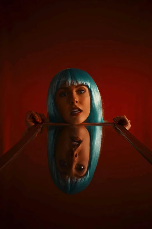 a woman with blue hair pulling off a pair of scissors