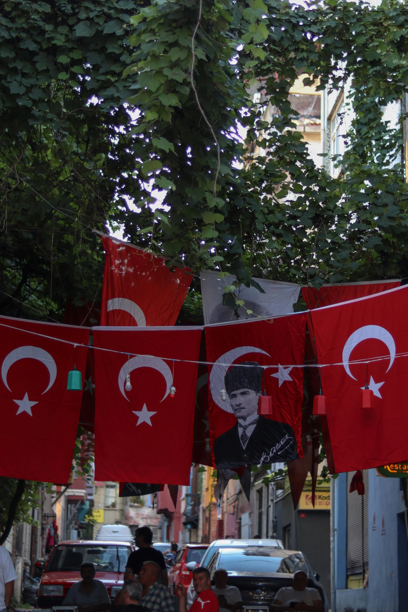 there are several flags hanging out in the street