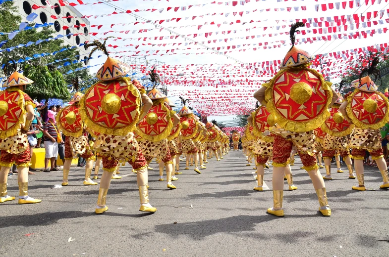 people on the street wearing red and gold costumes