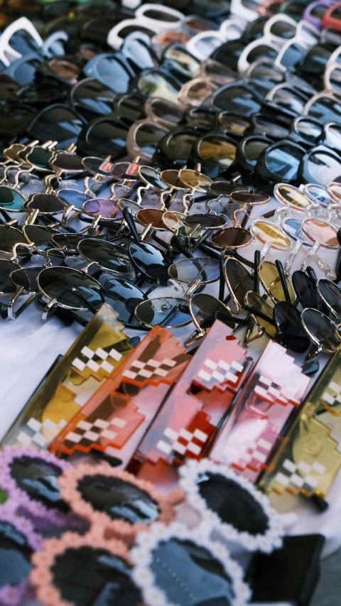 assortment of sunglasses sitting on table with other pieces of art