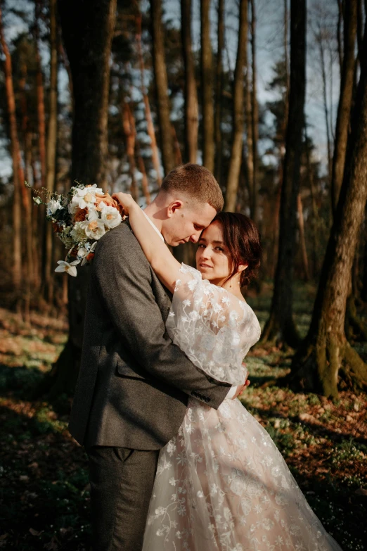 an engaged couple emcing in a wooded area