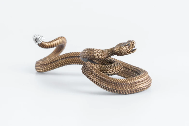 two large silver - plated snakes stand in the air