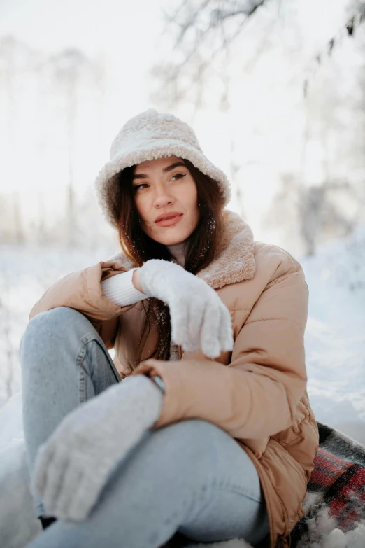a girl in a brown jacket and some snow