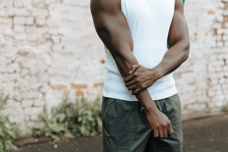 a black man with his hand over his shoulder