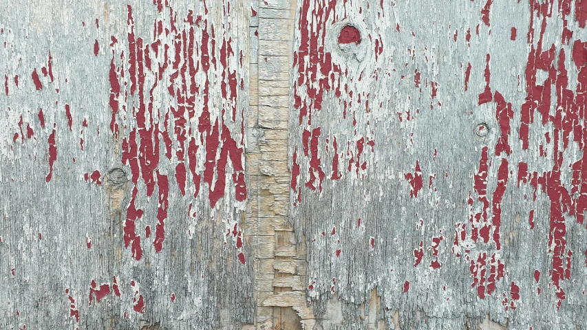 a dirty wall with red paint