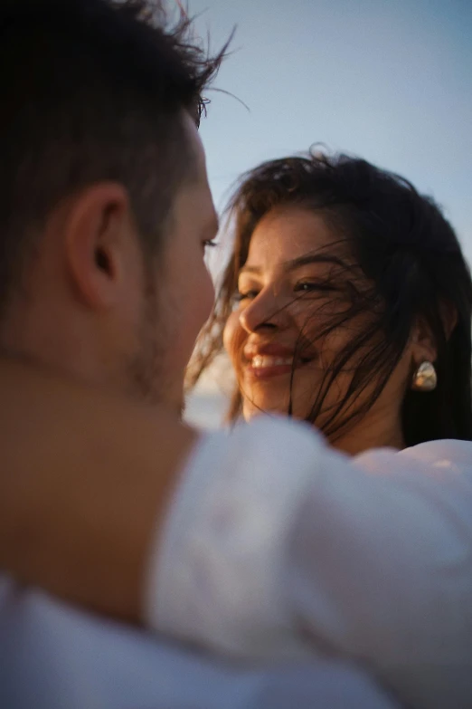 a man and a woman with very long hair laughing at each other