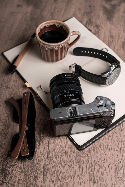 a camera and some accessories on a wooden surface