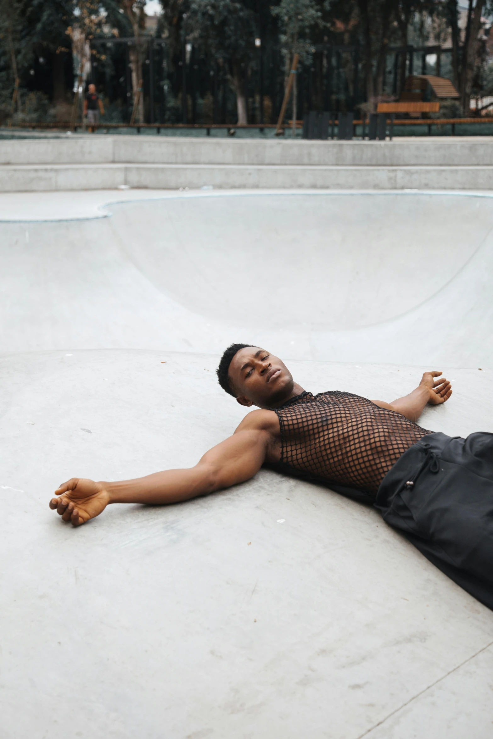 a man in black shirt laying down on the ground