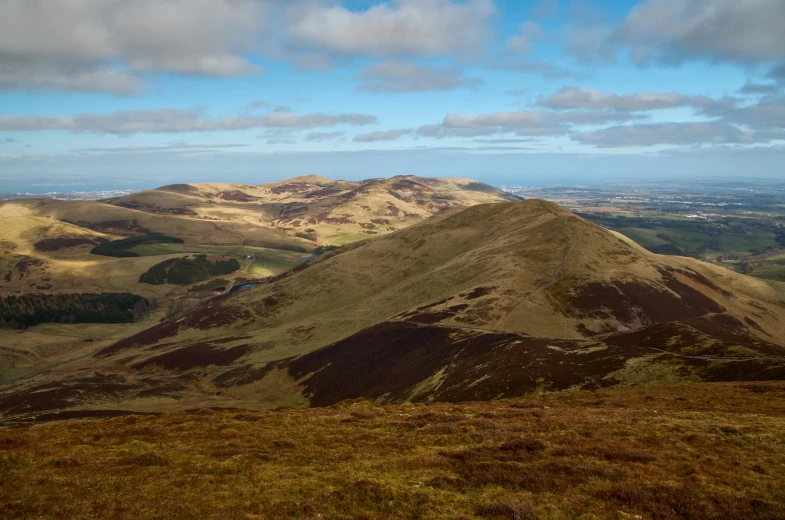 three hills overlooking the valley below are very brown