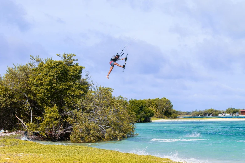 man is wake boarding in a lake in the daytime