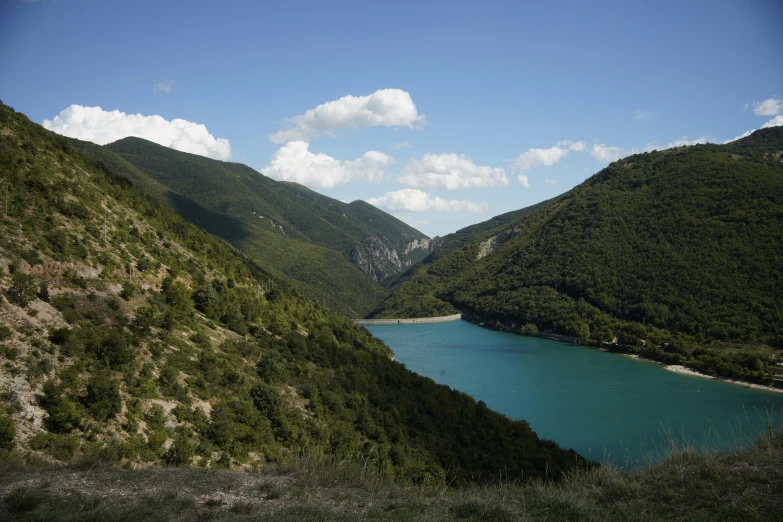 a scenic view of a river from the bottom of some mountains