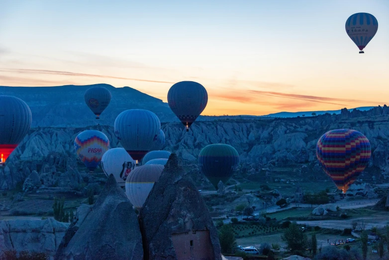 there are several air balloons flying above the ground