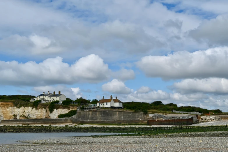 a scenic image with some clouds over a lighthouse