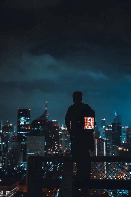 a man standing on top of a metal bar next to a neon sign