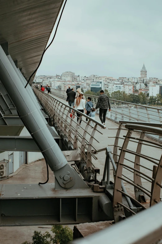 a crowd of people walk up the stairs of an observation platform