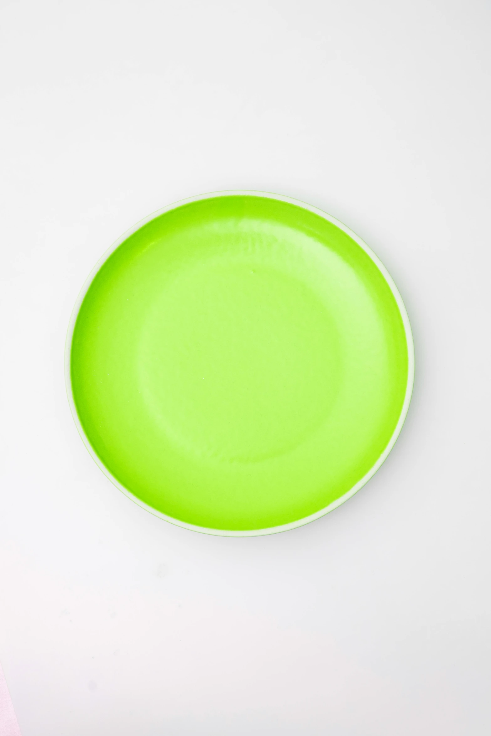 a green dish sitting on top of a white table