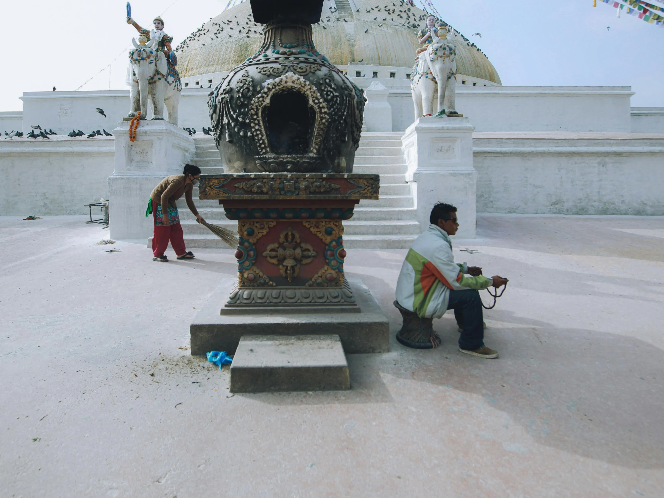 people are standing in front of a large vase