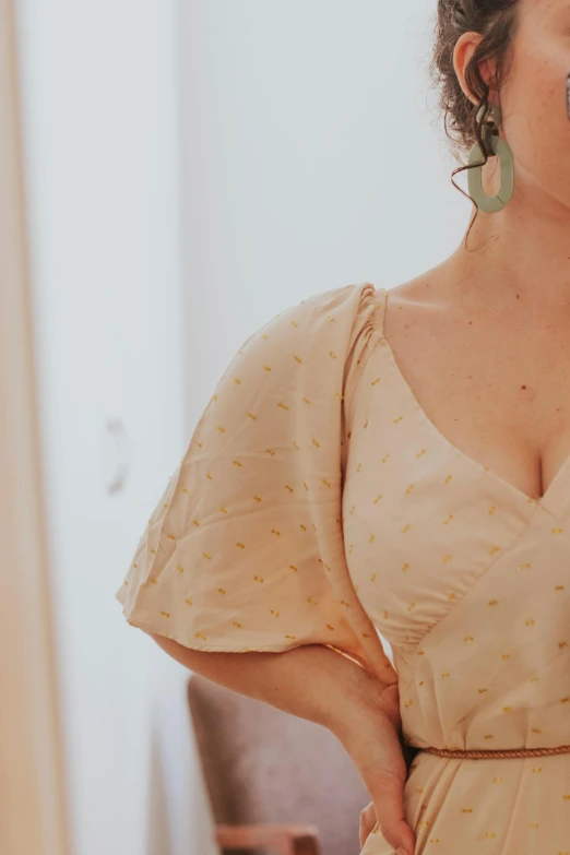 a woman wearing an orange dress in a bathroom