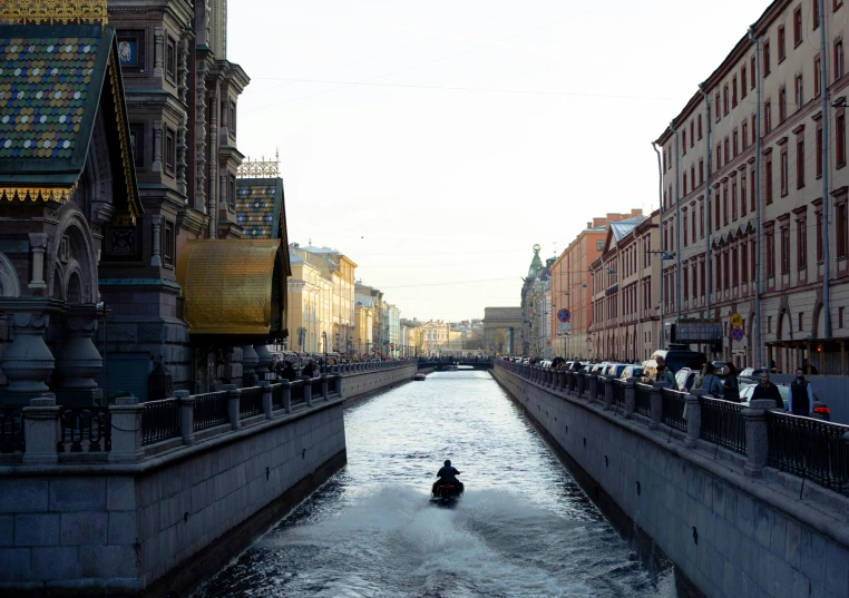 a man riding a jet ski down a narrow river