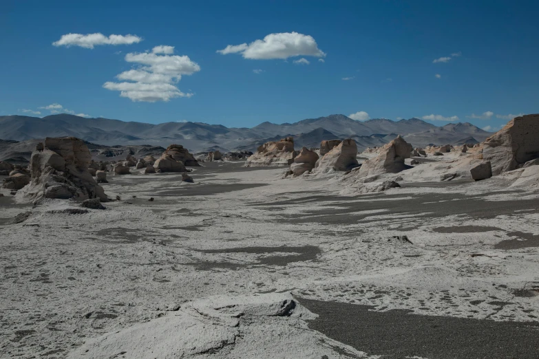 a sandy landscape with many mounds and boulders