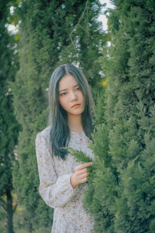 the woman is holding a bunch of small plants