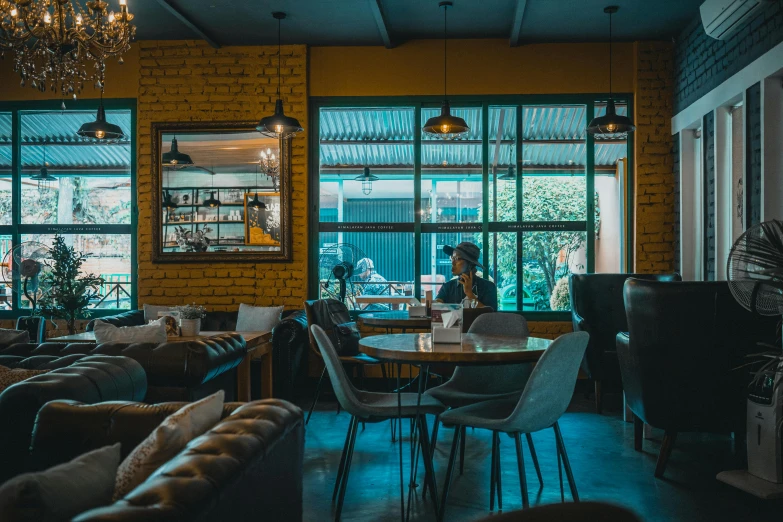 a restaurant filled with furniture and a chandelier